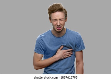 Young Caucasian Boy Suffering From Sudden Heart Attack. Stressed Teen Guy Having Chest Pain. Health Problem Concept.