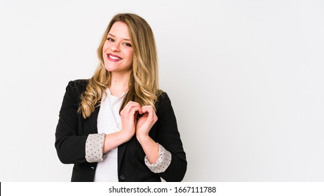 Young caucasian business woman isolated on white background Young caucasian bussines womansmiling and showing a heart shape with hands.