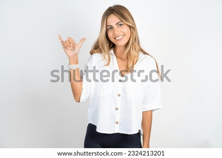 Young caucasian business woman wearing white shirt over white background showing up number six Liu with fingers gesture in sign Chinese language