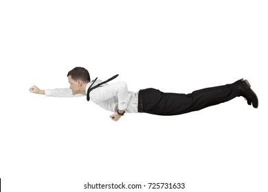 Young Caucasian businessman flying in the studio with a superhero pose, isolated white background - Powered by Shutterstock