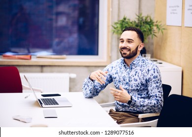 Young caucasian businessman gesturing during discussion in his office. Man working in office