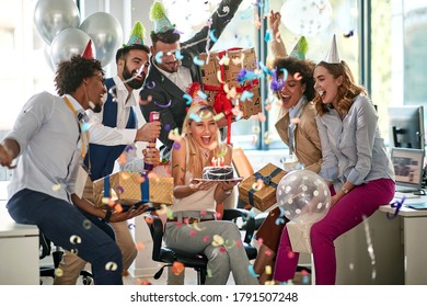 Young caucasian businesswoman surprised by her colleagues for her birthday at work in office.  - Powered by Shutterstock