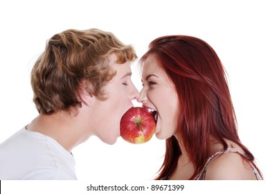 Young caucasian couple biting red apple over white background.