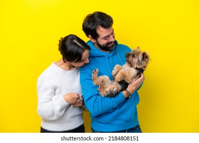 Young Caucasian Couple Holding A Dog