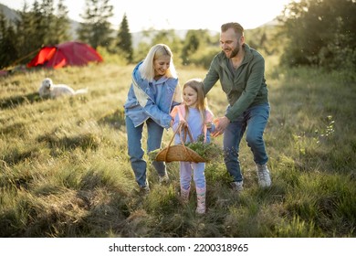 Young caucasian couple with little girl have fun while travel in the mountains. Happy family spending summer vacation at campsite - Powered by Shutterstock