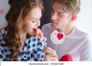 Young Caucasian Couple In Love Eating Sweets