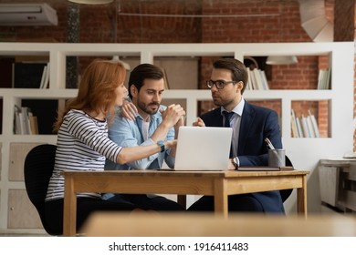 Young Caucasian couple talk consult with male realtor or broker at meeting in office. Man real estate agent have consultation with spouses, discuss house rent or bank loan. Realty, rental concept.