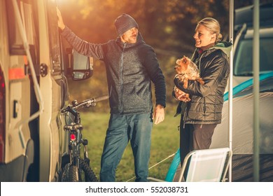 Young Caucasian Couples With Dog Motorhome RV Camping. Campground Fun.