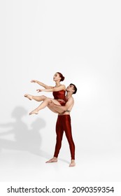 Young Caucasian Dance Couple Dancing Classical Ballet Dance. Choreography Concept. Man With Tattoo Holding Woman In Arms. Elegant People Isolated On White Background In Studio. Copy Space