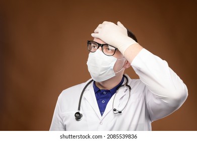 Young Caucasian Doctor In A Medical Uniform Makes A Facepalm Gesture. Medical Errors And Stupidity