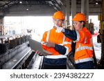Young caucasian engineer man and woman checking train with laptop in station, team engineer inspect system transport, technician examining infrastructure, transportation and industry.