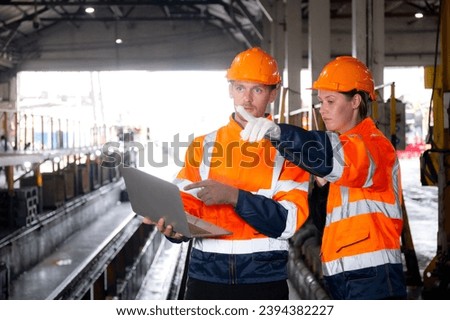 Young caucasian engineer man and woman checking train with laptop in station, team engineer inspect system transport, technician examining infrastructure, transportation and industry.