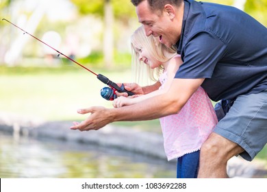 Young Caucasian Father and Daughter Having Fun Fishing At The Lake. - Powered by Shutterstock