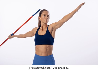 Young Caucasian female athlete prepares to throw a javelin on a white background. Her focused expression and athletic stance highlight the intensity of the sport. - Powered by Shutterstock