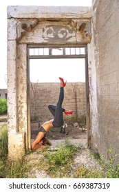 Young caucasian female practising yoga in abandoned ruins in Ras al Khaimah, United Arab Emirates - June 2017