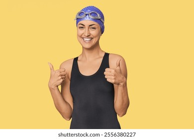 Young Caucasian female professional swimmer raising both thumbs up, smiling and confident. - Powered by Shutterstock