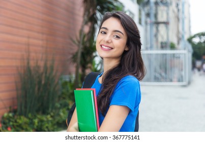Young caucasian female student with blue shirt in the city