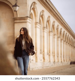 Young caucasian female walking along historic european architecture. - Powered by Shutterstock