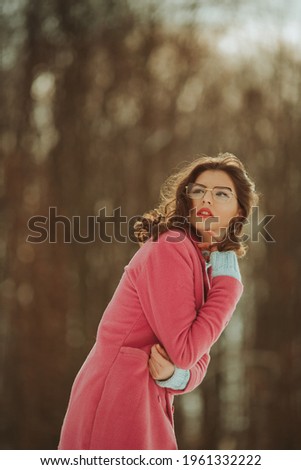 Similar – Portrait of a girl in red dress on a wooden door