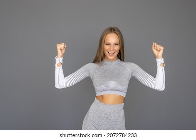 Young caucasian fitness woman posing in a white background cheering carefree and excited. Victory concept. - Powered by Shutterstock