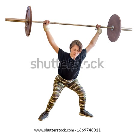 Young caucasian girl of 13 years old does snatch exercise during weightlifting competition with heavy barbell. Kid's weightlifting sports and competition, active sports. Isolated on white.
