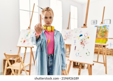 Young Caucasian Girl At Art Studio Pointing With Finger Up And Angry Expression, Showing No Gesture 