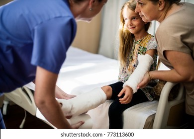 Young Caucasian Girl With Broken Arm In Plaster Cast