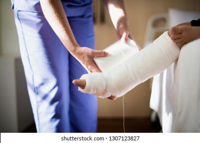 Young Caucasian Girl With Broken Leg In Plaster Cast