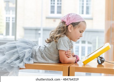 Young Caucasian Girl Using Education Interactive Touch Screen In Museum