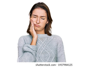 Young caucasian girl wearing casual clothes touching mouth with hand with painful expression because of toothache or dental illness on teeth. dentist 
