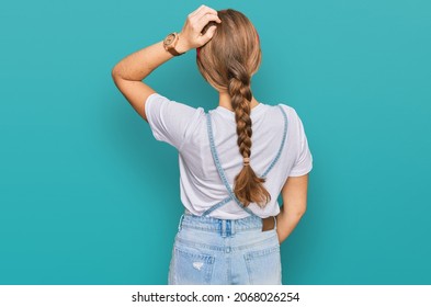 Young Caucasian Girl Wearing Casual Clothes Backwards Thinking About Doubt With Hand On Head 