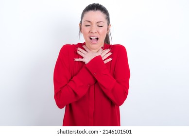 young caucasian girl wearing red shirt over white background shouting suffocate because painful strangle. Health problem. Asphyxiate and suicide concept.