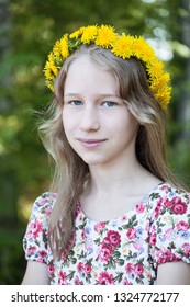 Young Caucasian Girl In Yellow Dandelion Crown On Summer Outdoor Background