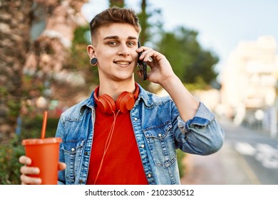 Young Caucasian Guy Drinking Soda Speaking On The Phone At The City