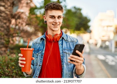 Young Caucasian Guy Drinking Soda Using Smartphone At The City