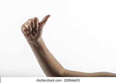 Young caucasian hands making hitch-hiking gesture from right to left isolated on a white background. Gesture is approve or like or number one sign too. Elbow is supported by a white table with shadow