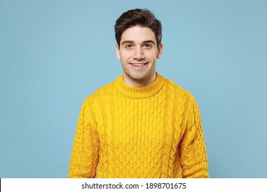 Young Caucasian Handsome Attractive Cheerful Friendly Student Man 20s Wearing Casual Knitted Cozy Yellow Fashionable Sweater Looking Camera With Smile Isolated On Blue Color Background Studio Portrait