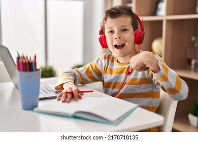 Young Caucasian Kid Doing Homework At Home Pointing Finger To One Self Smiling Happy And Proud 