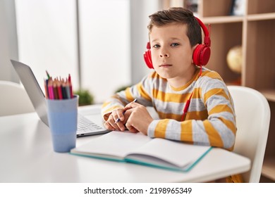 Young Caucasian Kid Doing Homework At Home Thinking Attitude And Sober Expression Looking Self Confident 