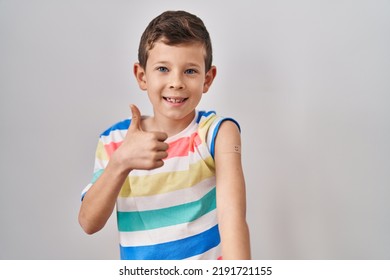 Young Caucasian Kid Getting Vaccine Showing Arm With Band Aid Smiling Happy And Positive, Thumb Up Doing Excellent And Approval Sign 