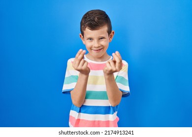 Young Caucasian Kid Standing Over Blue Background Doing Money Gesture With Hands, Asking For Salary Payment, Millionaire Business 