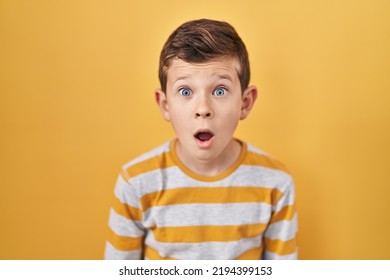 Young caucasian kid standing over yellow background afraid and shocked with surprise expression, fear and excited face.  - Shutterstock ID 2194399153