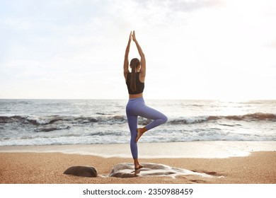 Young caucasian lady enjoy morning workout, silence, calmness and relax, breathing exercises, practicing yoga on sea beach. Sports, lifestyle and body care, weight loss outdoor, full length - Powered by Shutterstock