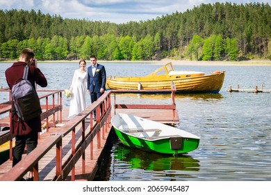 Young caucasian Lithuanian couple on bridge pose for photographer with lake panorama - Powered by Shutterstock