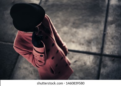 Young Caucasian Mafia Woman In Coat And Hat On A Street In Winter.