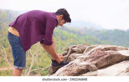 Young caucasian male hiker tying shoelaces and getting ready for trekking in the forest. Concept of Travel happy emotions lifestyle active adventure vacations. - Powered by Shutterstock