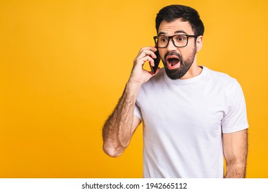 Young caucasian man angry, frustrated and furious with his mobile phone, angry with customer service. Isolated over yellow background. - Powered by Shutterstock