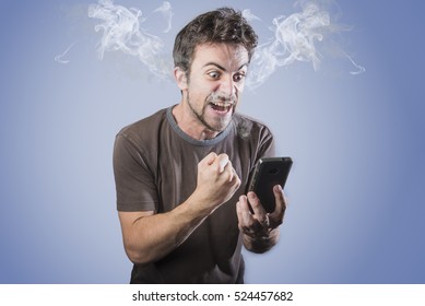 Young caucasian man angry, frustrated and furious with his phone, angry with customer service, steaming with rage