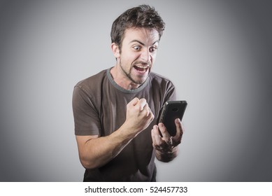 Young Caucasian Man Angry, Frustrated And Furious With His Phone, Angry With Customer Service, 