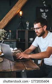 Young Caucasian Man With Beard Work At Home, Freelance Work, Use Laptop Computer. 